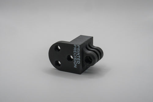 Black 3D-printed component with 'Printed Precision' text on a gray background